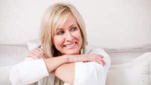 Woman smiling sitting on a couch